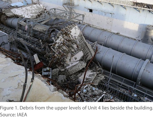 Figure 1. Debris from the upper levels of Unit 4 lies beside the building. Source: IAEA via NASA